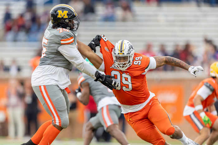 American offensive lineman Javon Foster of Missouri (75) battle National edge Marshawn Kneeland of Western Michigan (99).
